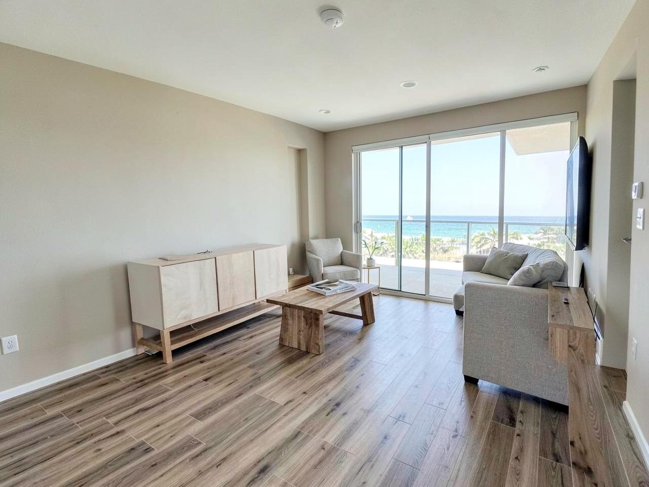 Renovated Gulf-front vacation rental living area with durable plank flooring